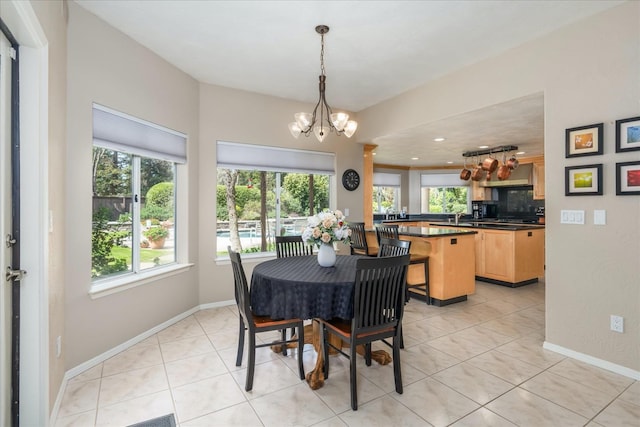 dining area featuring baseboards, recessed lighting, light tile patterned flooring, and a chandelier