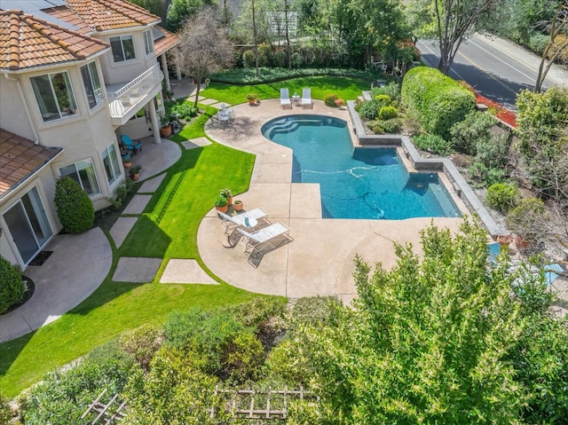 outdoor pool featuring a patio and a yard