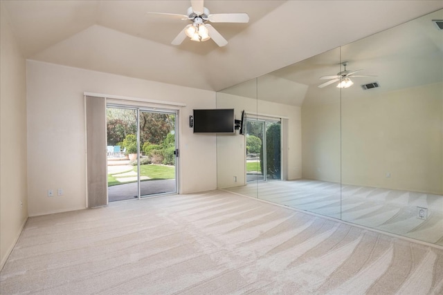 unfurnished room with plenty of natural light, ceiling fan, light carpet, and high vaulted ceiling