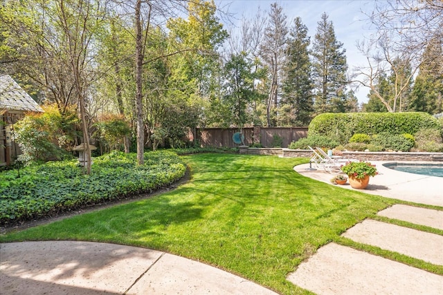 view of yard featuring a fenced in pool, a fenced backyard, and a patio area