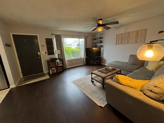 854 La Playa Ct, Manteca, CA 95336 - living room with dark wood-type flooring, baseboards, a textured ceiling, and ceiling fan