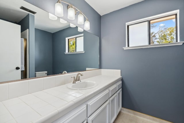100 Rosewood Cir, Madera, CA 93637 - full bathroom featuring toilet, vanity, baseboards, and visible vents