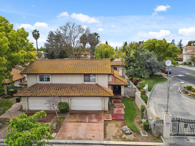 100 Rosewood Cir, Madera, CA 93637 - view of front facade featuring stucco siding, driveway, fence, and a tiled roof