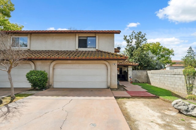 100 Rosewood Cir, Madera, CA 93637 - mediterranean / spanish house with a tile roof, concrete driveway, stucco siding, fence, and an attached garage