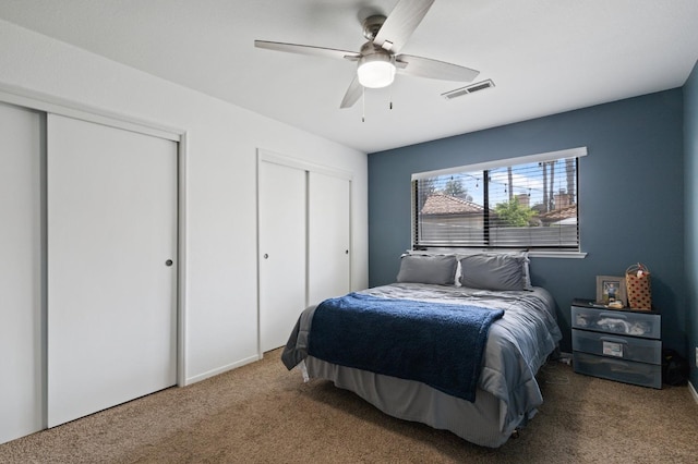 100 Rosewood Cir, Madera, CA 93637 - carpeted bedroom featuring two closets, ceiling fan, and visible vents