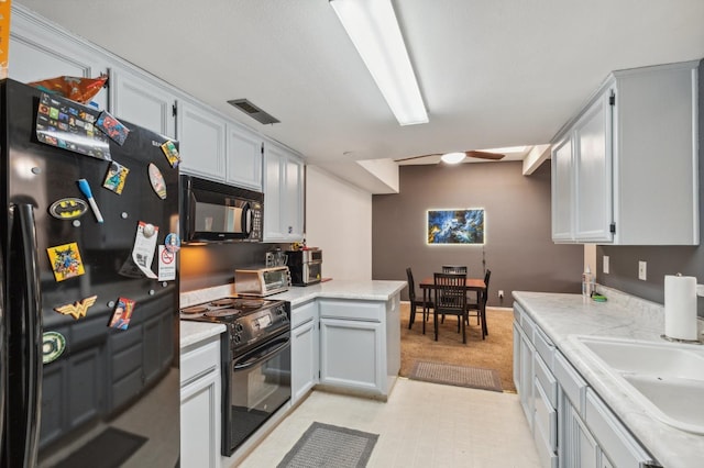 100 Rosewood Cir, Madera, CA 93637 - kitchen featuring light countertops, visible vents, a toaster, a sink, and black appliances