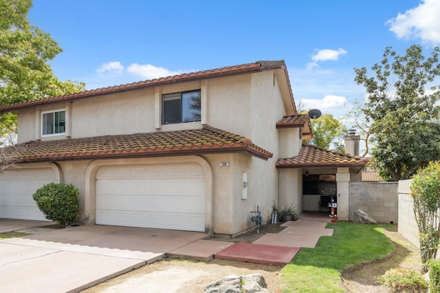 100 Rosewood Cir, Madera, CA 93637 - mediterranean / spanish-style home with a tiled roof, stucco siding, fence, and an attached garage