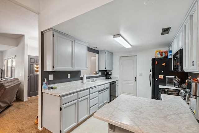 100 Rosewood Cir, Madera, CA 93637 - kitchen featuring a sink, black appliances, a peninsula, and light carpet