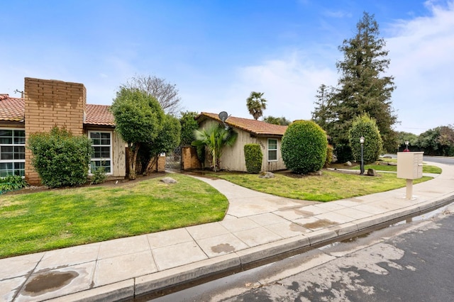 1063 Pierce Dr, Clovis, CA 93612 - view of front of property featuring a front yard, a tiled roof, and stucco siding