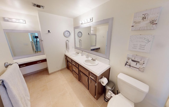 7186 N Gregory Ave, Fresno, CA 93722 - full bath with toilet, tile patterned flooring, double vanity, and baseboards