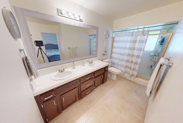 7186 N Gregory Ave, Fresno, CA 93722 - bathroom with a shower with shower curtain, double vanity, tile patterned flooring, toilet, and ensuite bathroom