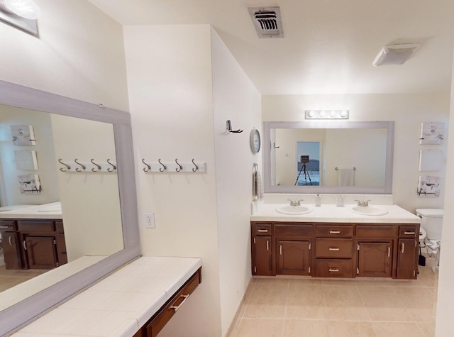 7186 N Gregory Ave, Fresno, CA 93722 - full bath featuring double vanity, tile patterned floors, and toilet