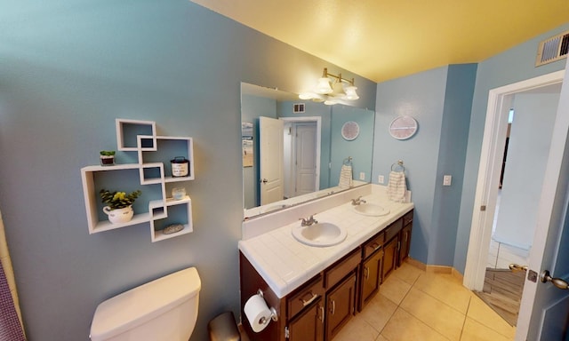 7186 N Gregory Ave, Fresno, CA 93722 - full bath with tile patterned flooring, toilet, double vanity, and baseboards
