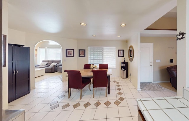 7186 N Gregory Ave, Fresno, CA 93722 - dining room with healthy amount of natural light, recessed lighting, light tile patterned floors, arched walkways, and baseboards