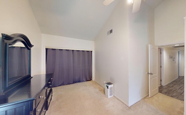 7186 N Gregory Ave, Fresno, CA 93722 - interior space with light colored carpet, vaulted ceiling, a ceiling fan, and baseboards