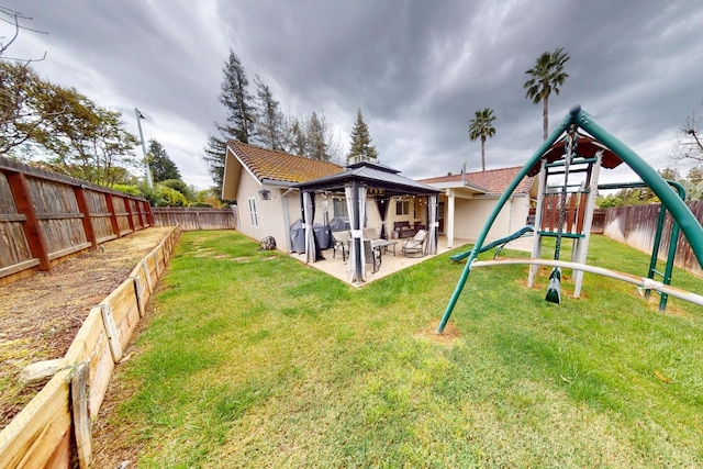 7186 N Gregory Ave, Fresno, CA 93722 - rear view of property featuring a playground, a gazebo, a patio area, and stucco siding
