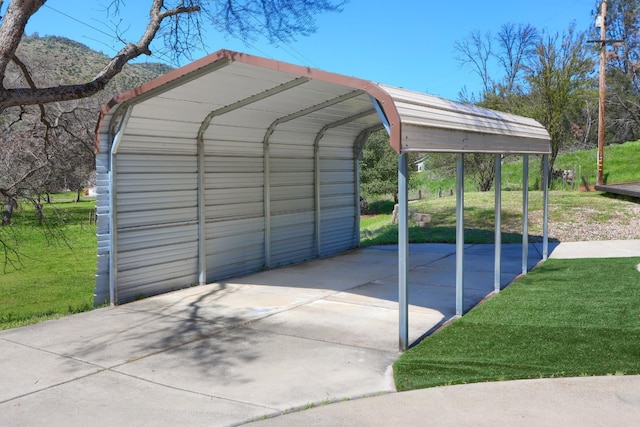 view of parking / parking lot with a detached carport and driveway