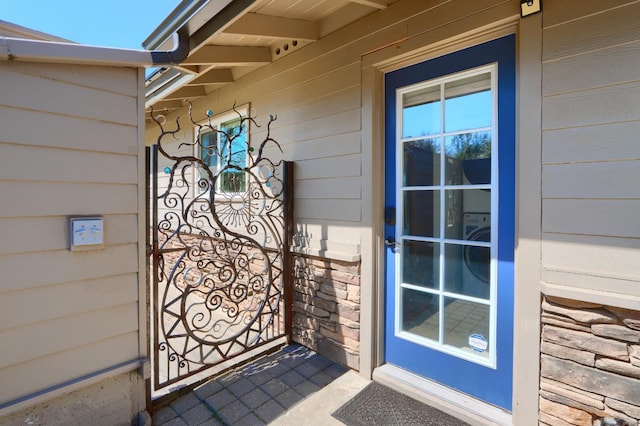 doorway to property featuring stone siding