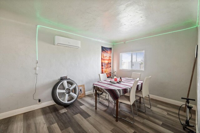 dining area featuring a wall mounted air conditioner, baseboards, and wood finished floors