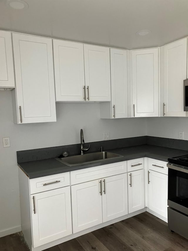 3012 N Fruit, Fresno, CA 93705 - kitchen with stainless steel appliances, dark countertops, a sink, and white cabinetry