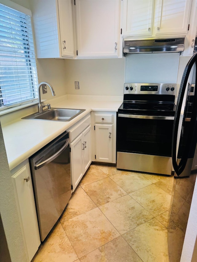 kitchen featuring stainless steel appliances, under cabinet range hood, a sink, and white cabinets