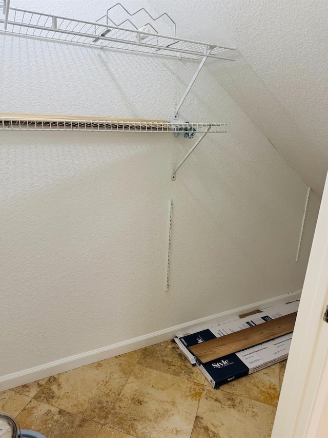walk in closet with vaulted ceiling