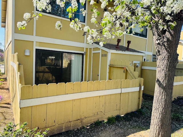 rear view of house with fence