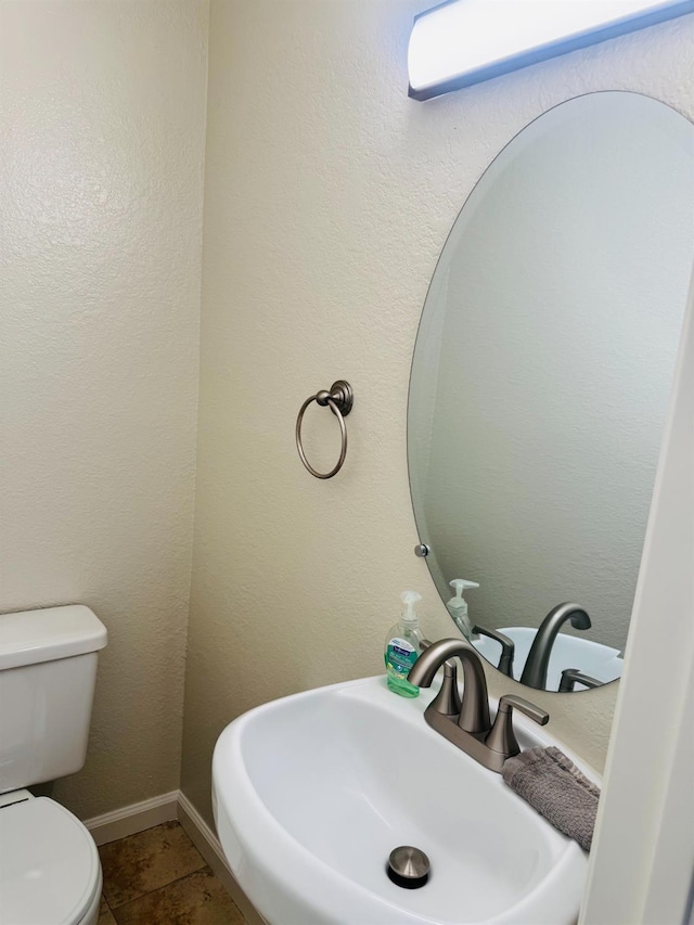 bathroom featuring a sink and toilet