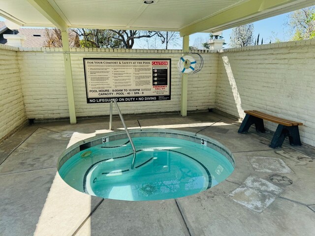 4875 N Backer Ave Unit 146, Fresno, CA 93726 - view of swimming pool featuring a community hot tub and fence