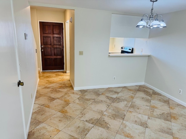 unfurnished dining area featuring baseboards and a chandelier