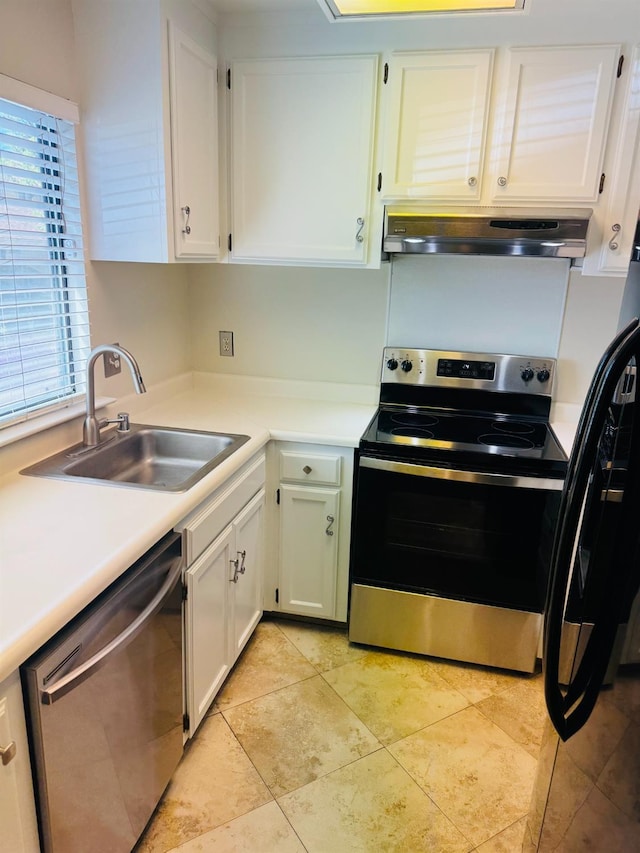 kitchen with stainless steel appliances, under cabinet range hood, a sink, white cabinetry, and light countertops