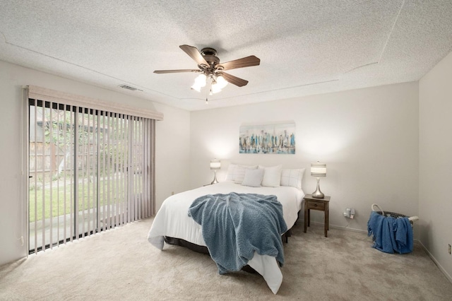 carpeted bedroom featuring visible vents, access to exterior, ceiling fan, and a textured ceiling
