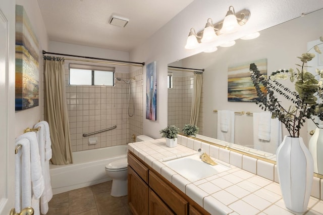 full bath with toilet, tile patterned floors, vanity, and shower / tub combo