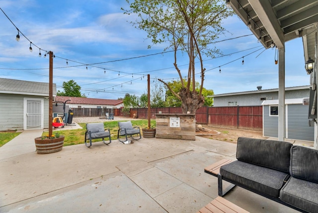 view of patio / terrace featuring a fenced backyard and an outbuilding