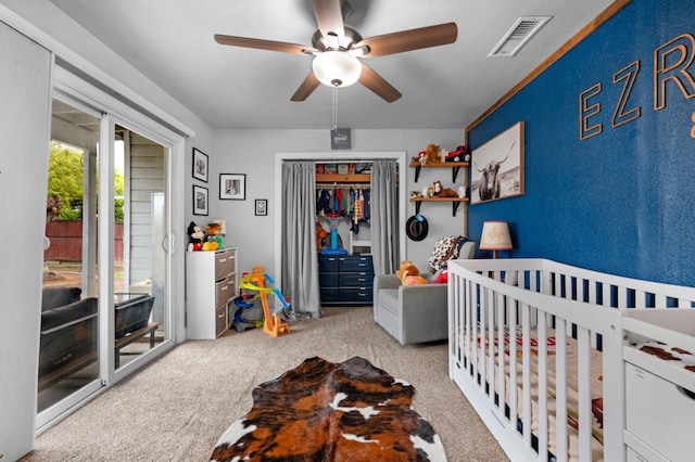 bedroom featuring a closet, carpet floors, visible vents, ceiling fan, and a textured wall