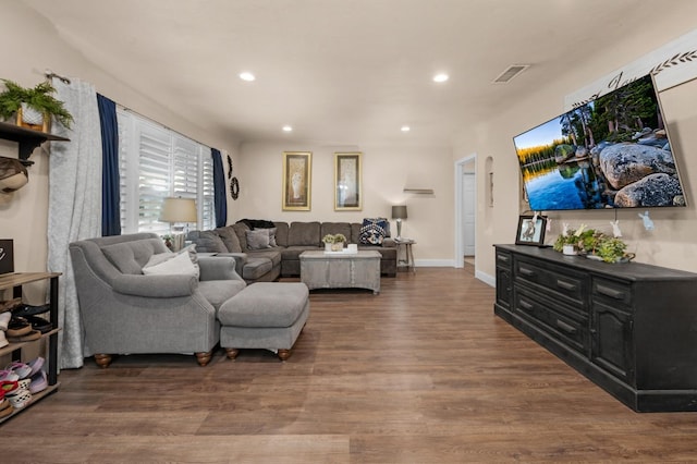 living area with recessed lighting, baseboards, visible vents, and wood finished floors