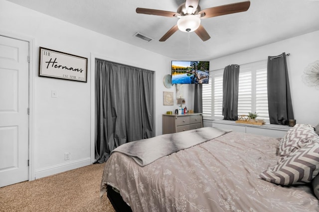 carpeted bedroom with baseboards, ceiling fan, and visible vents