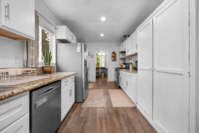 kitchen featuring dark wood-type flooring, white cabinets, and stainless steel appliances