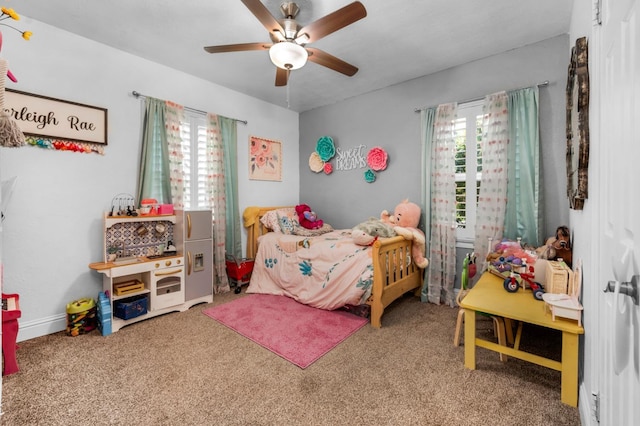 carpeted bedroom with multiple windows and a ceiling fan