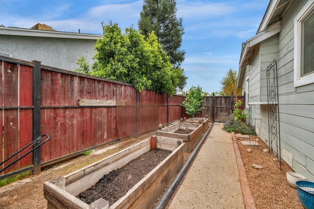 view of yard featuring a garden and a fenced backyard