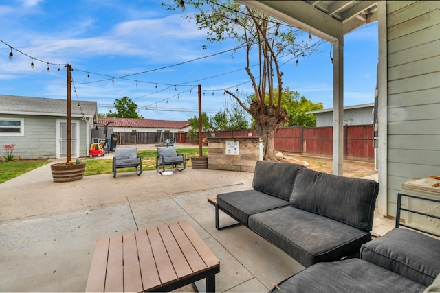 view of patio with an outdoor structure, a fenced backyard, and an outdoor hangout area
