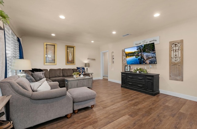 living area with wood finished floors, recessed lighting, baseboards, and visible vents