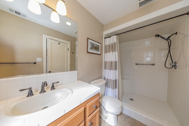 bathroom with toilet, tiled shower, vanity, tasteful backsplash, and visible vents