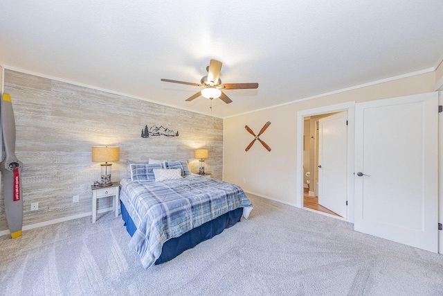 bedroom with ornamental molding, carpet, and a ceiling fan