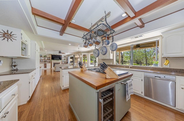 kitchen featuring stainless steel dishwasher, open floor plan, visible vents, and light wood-type flooring