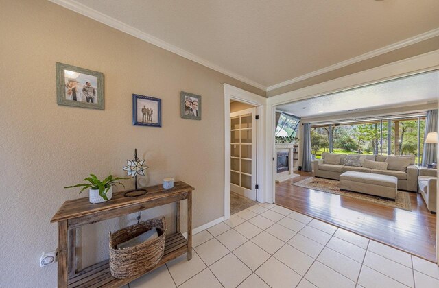 interior space featuring light tile patterned flooring, baseboards, and ornamental molding