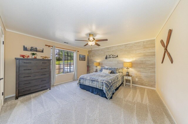 bedroom with crown molding, carpet, and an accent wall