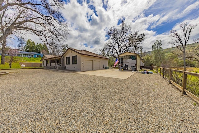 view of yard with fence, driveway, and an attached garage