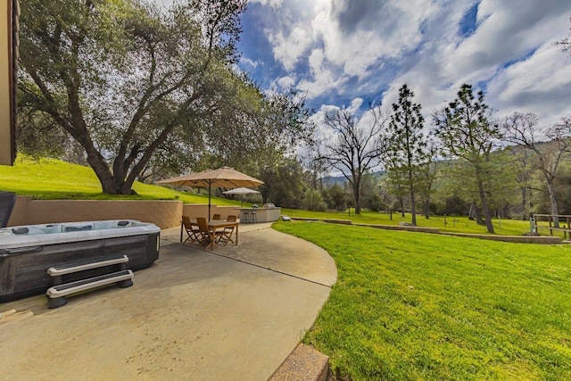 view of yard featuring a hot tub and a patio