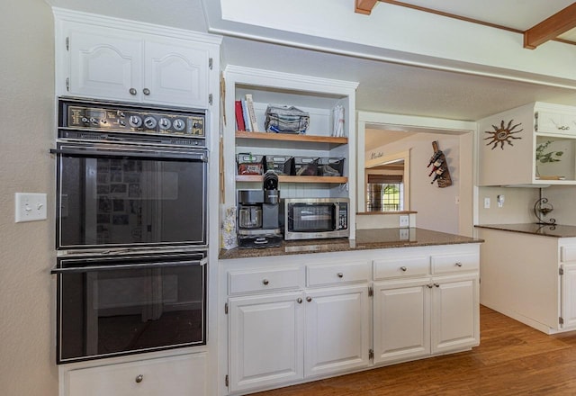 kitchen featuring white cabinetry, open shelves, stainless steel microwave, dobule oven black, and wood finished floors